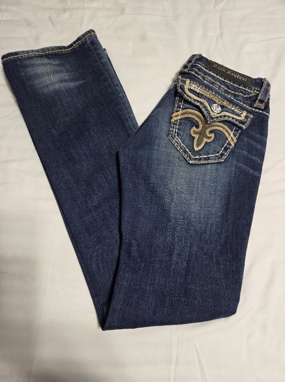 Rock Revival Women's Dark Indigo Boot Cut Jeans with Gold Embroidery Stiching.